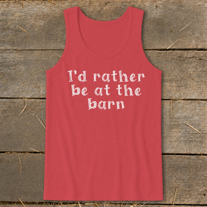 Coral tank top with white text "I'd rather be at the barn" on rustic wooden background.