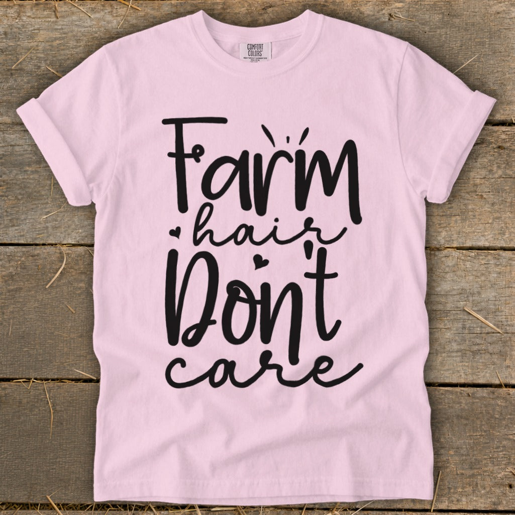 Pink t-shirt with black text reading "Farm hair don't care".