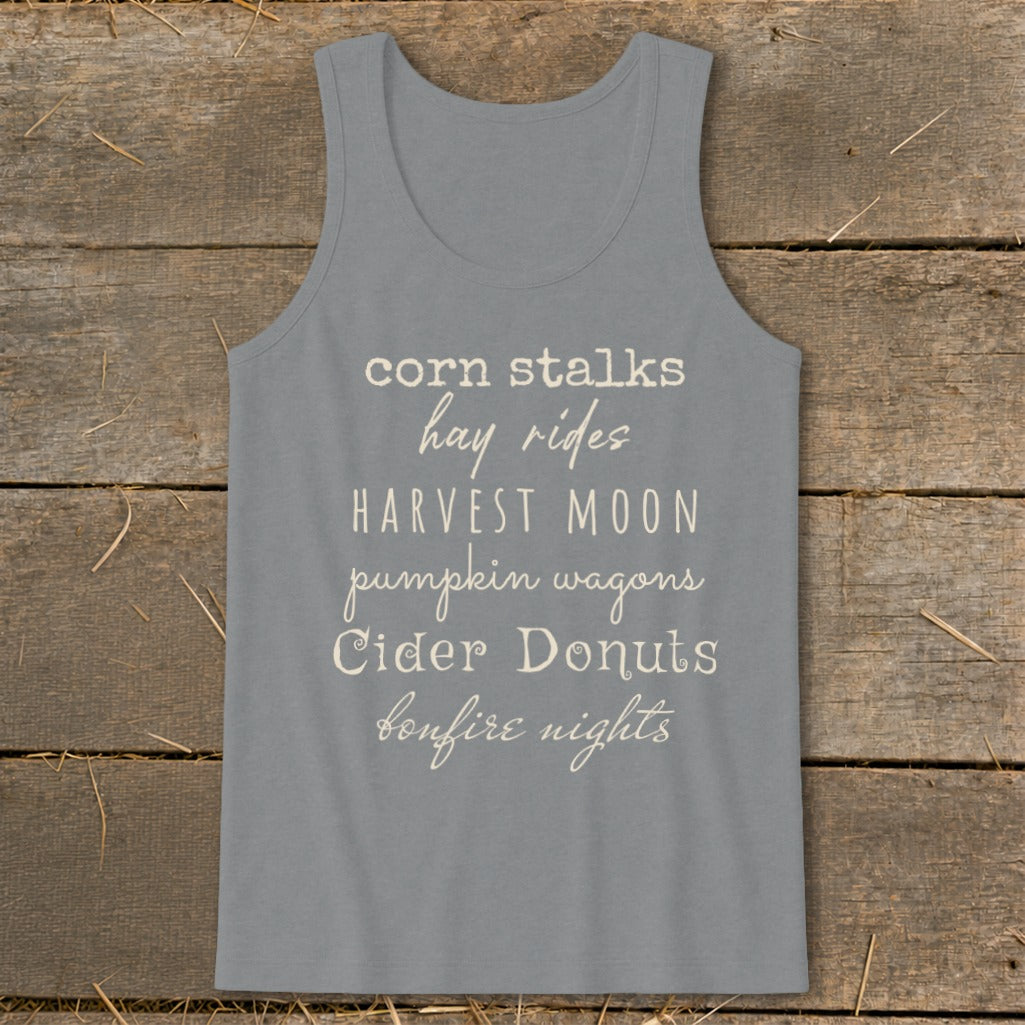 Gray tank top with list of fall activities: corn stalks, hay rides, harvest moon, pumpkin wagons, cider donuts, bonfire nights.