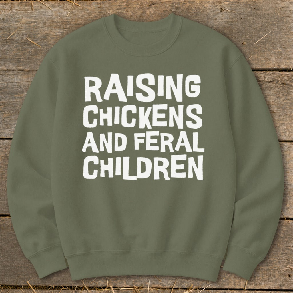 Olive green sweatshirt with white text "Raising Chickens and Feral Children."