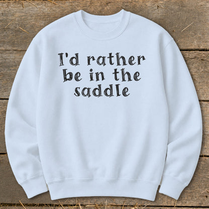 Light blue sweatshirt with black text "I'd rather be in the saddle".