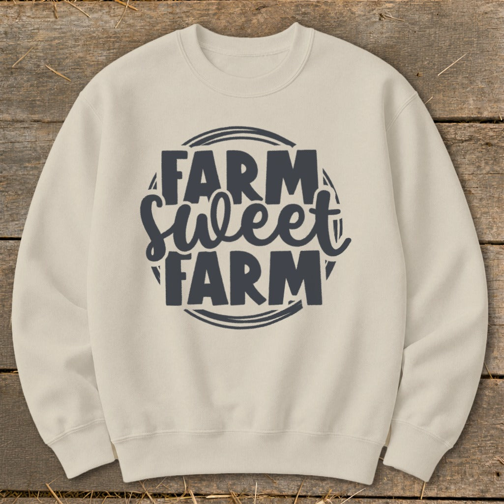 Cream sweatshirt with dark gray "FARM Sweet FARM" graphic on wooden background.