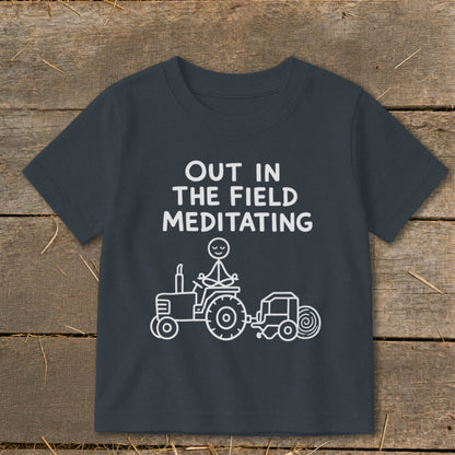 Dark gray t-shirt with white text and illustration of stick figure meditating on a tractor.
