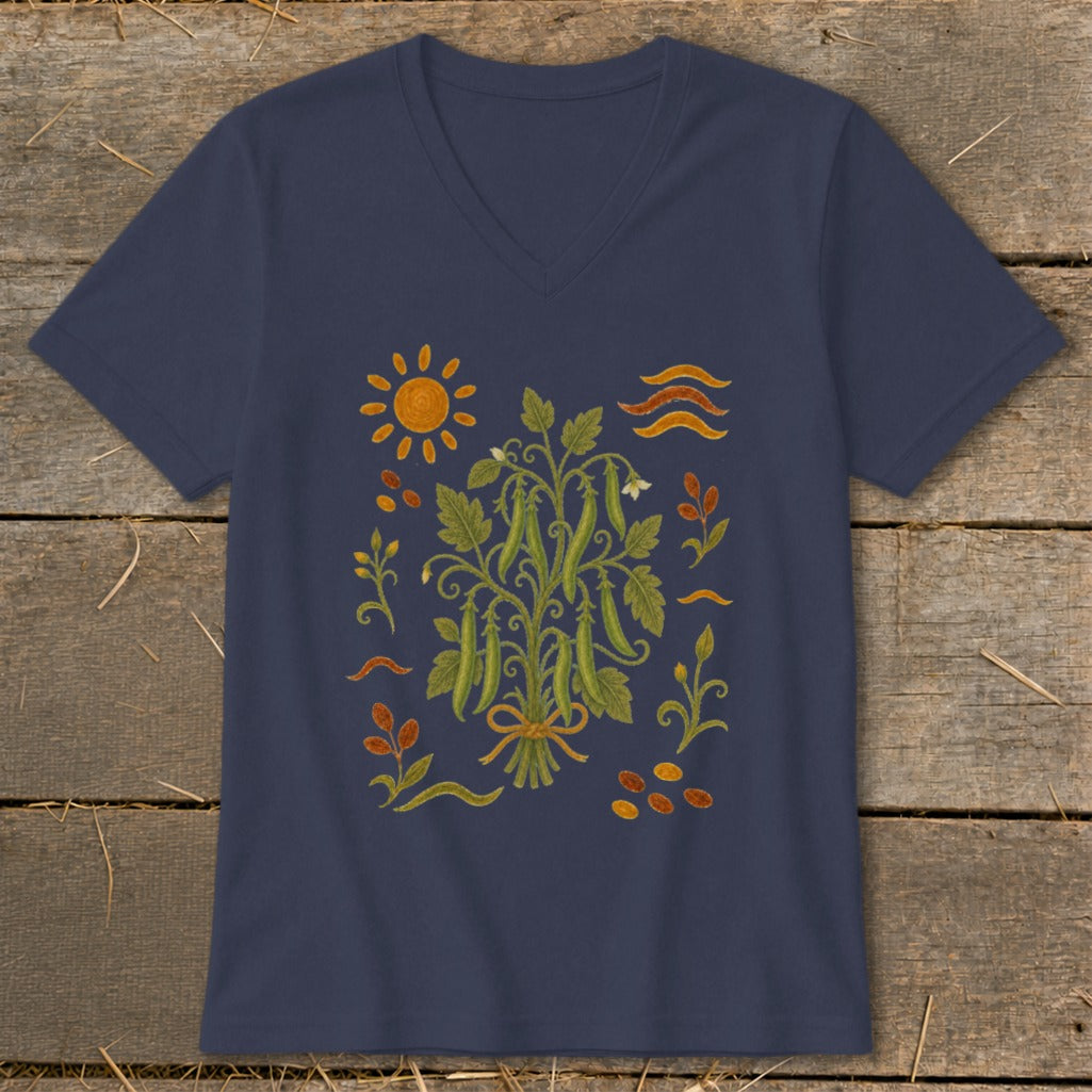 Navy t-shirt with a central illustration of a pea plant tied with a ribbon, surrounded by sun, leaves, and seeds.
