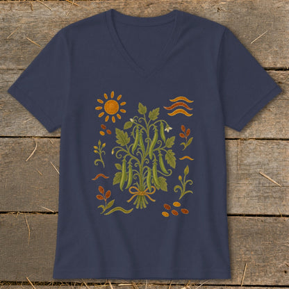 Navy t-shirt with a central illustration of a pea plant tied with a ribbon, surrounded by sun, leaves, and seeds.
