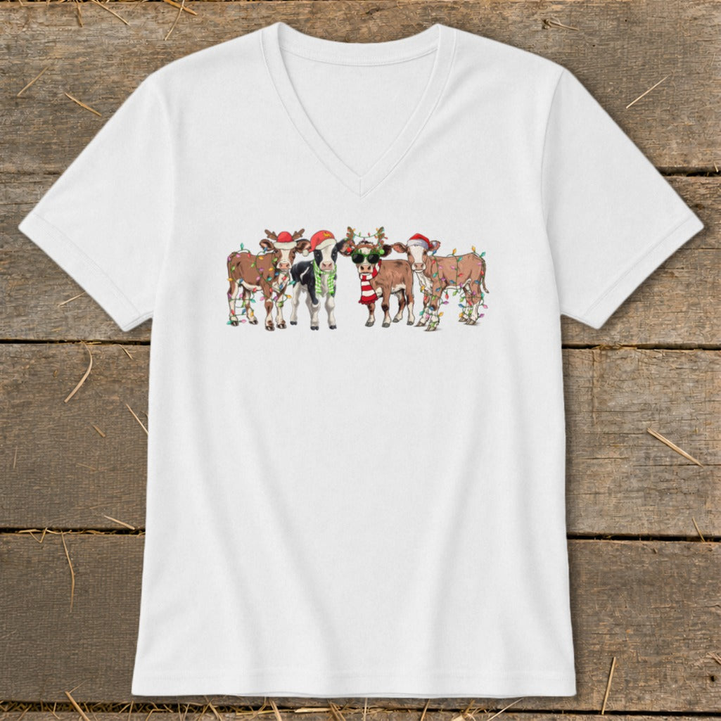 White t-shirt with cartoon cows wearing Santa hats and Christmas lights.