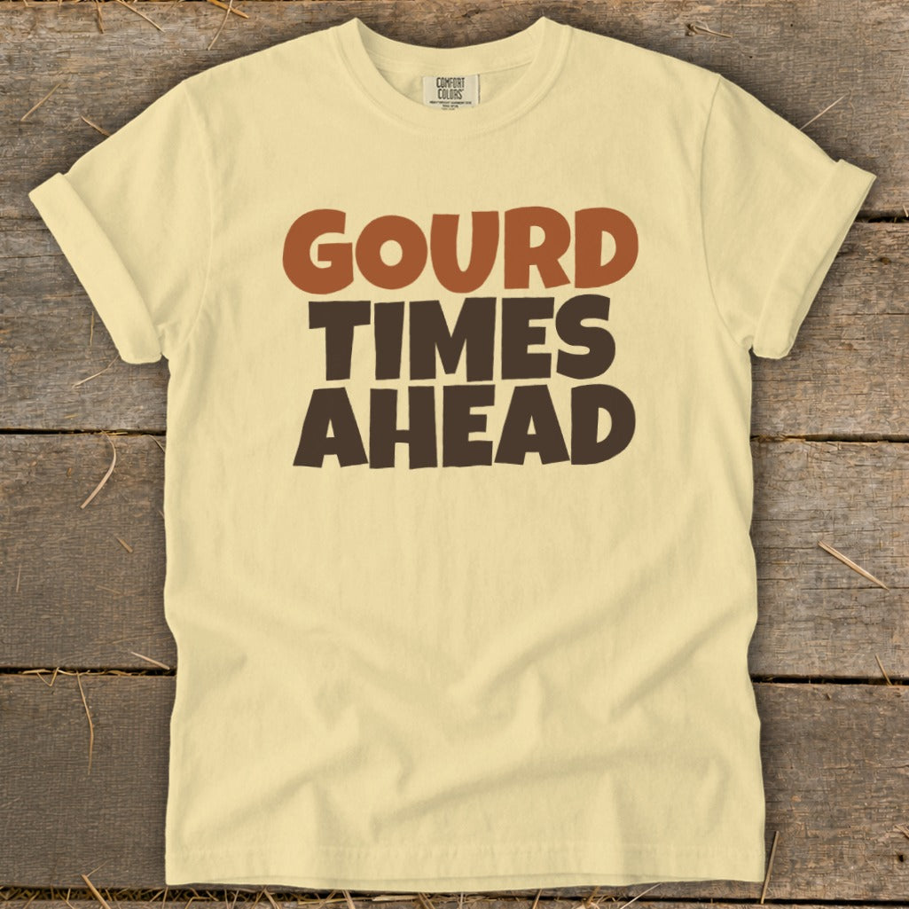 Light yellow t-shirt with "Gourd Times Ahead" printed in brown and dark brown text.
