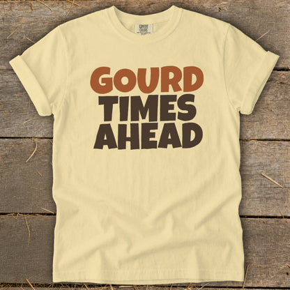 Light yellow t-shirt with "Gourd Times Ahead" printed in brown and dark brown text.