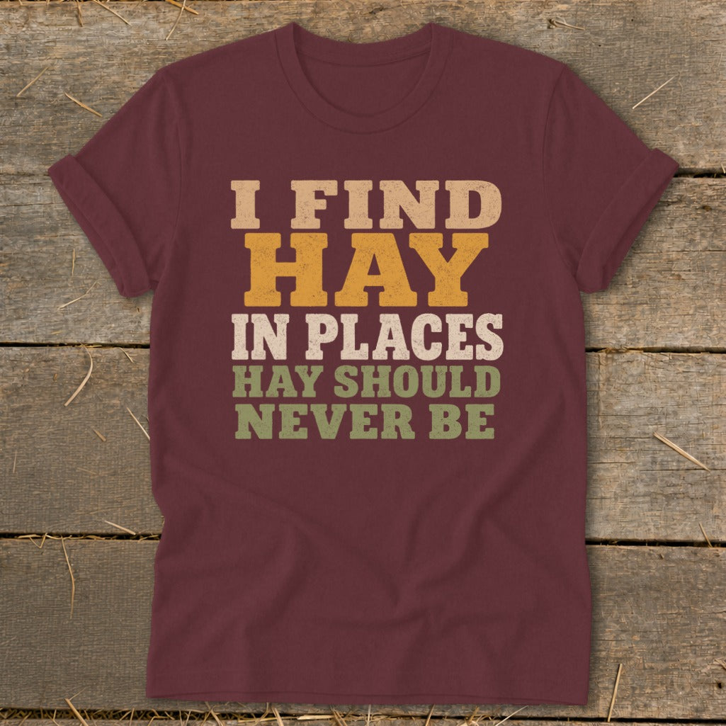 Maroon t-shirt with text "I FIND HAY IN PLACES HAY SHOULD NEVER BE".
