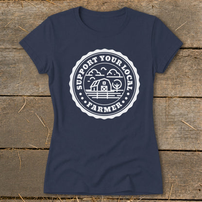 Navy blue t-shirt with a white circular emblem reading "Support Your Local Farmer" with barn and trees graphic.