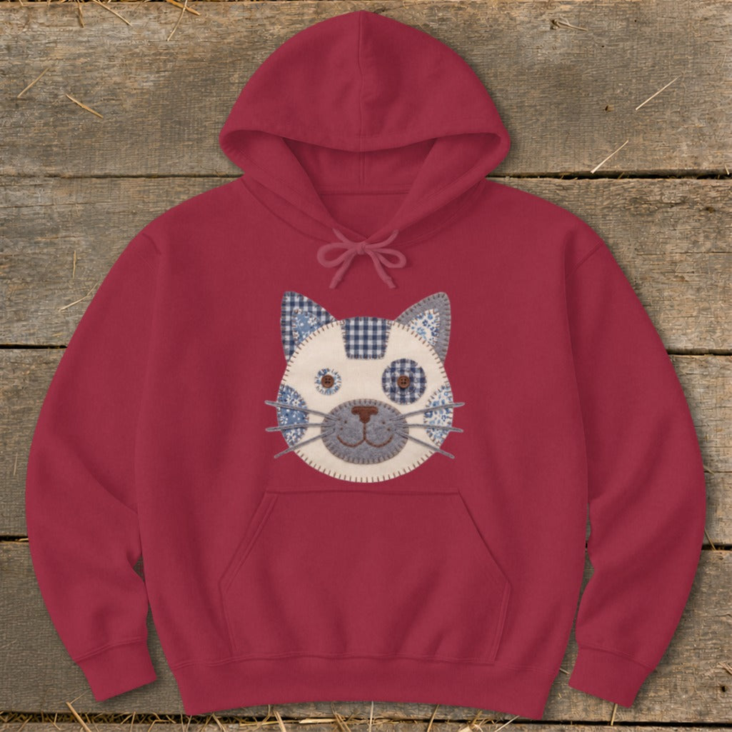 Maroon hoodie with a quilted cat face design on the front.