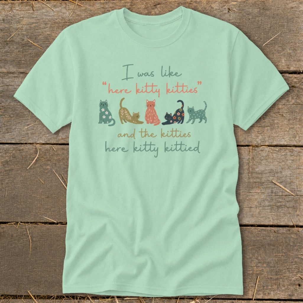 Light green t-shirt with cats and text: "I was like 'here kitty kitties' and the kitties here kitty kittied."