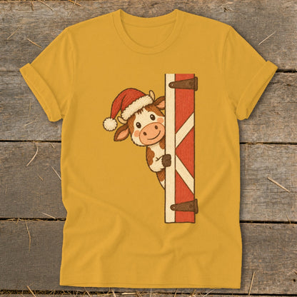 Cute cow in Santa hat peeking around a red barn door graphic.