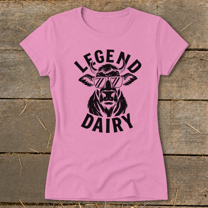 Pink t-shirt with black graphic of a cow wearing sunglasses and text "LEGEND DAIRY".