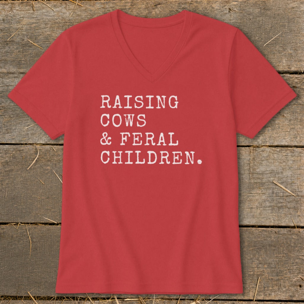 Red v-neck t-shirt with white text "RAISING COWS & FERAL CHILDREN."