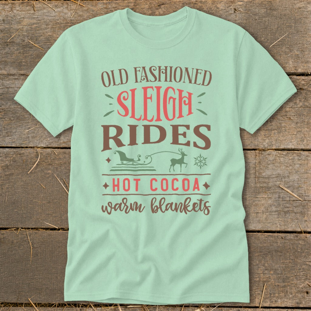 Pale green t-shirt with text Old Fashioned Sleigh Rides, Hot Cocoa, warm blankets.