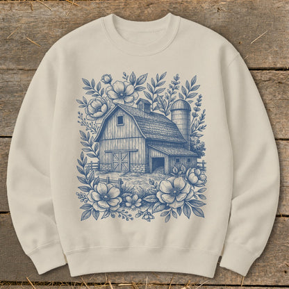 Cream sweatshirt with blue line art of a barn, silo, and floral accents.
