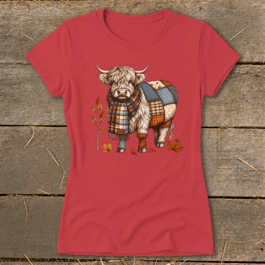 T-shirt with a Highland cow wearing a scarf, decorated with patchwork and fall leaves.
