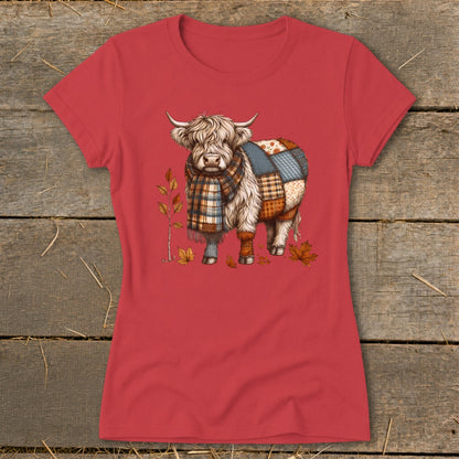 T-shirt with a Highland cow wearing a scarf, decorated with patchwork and fall leaves.