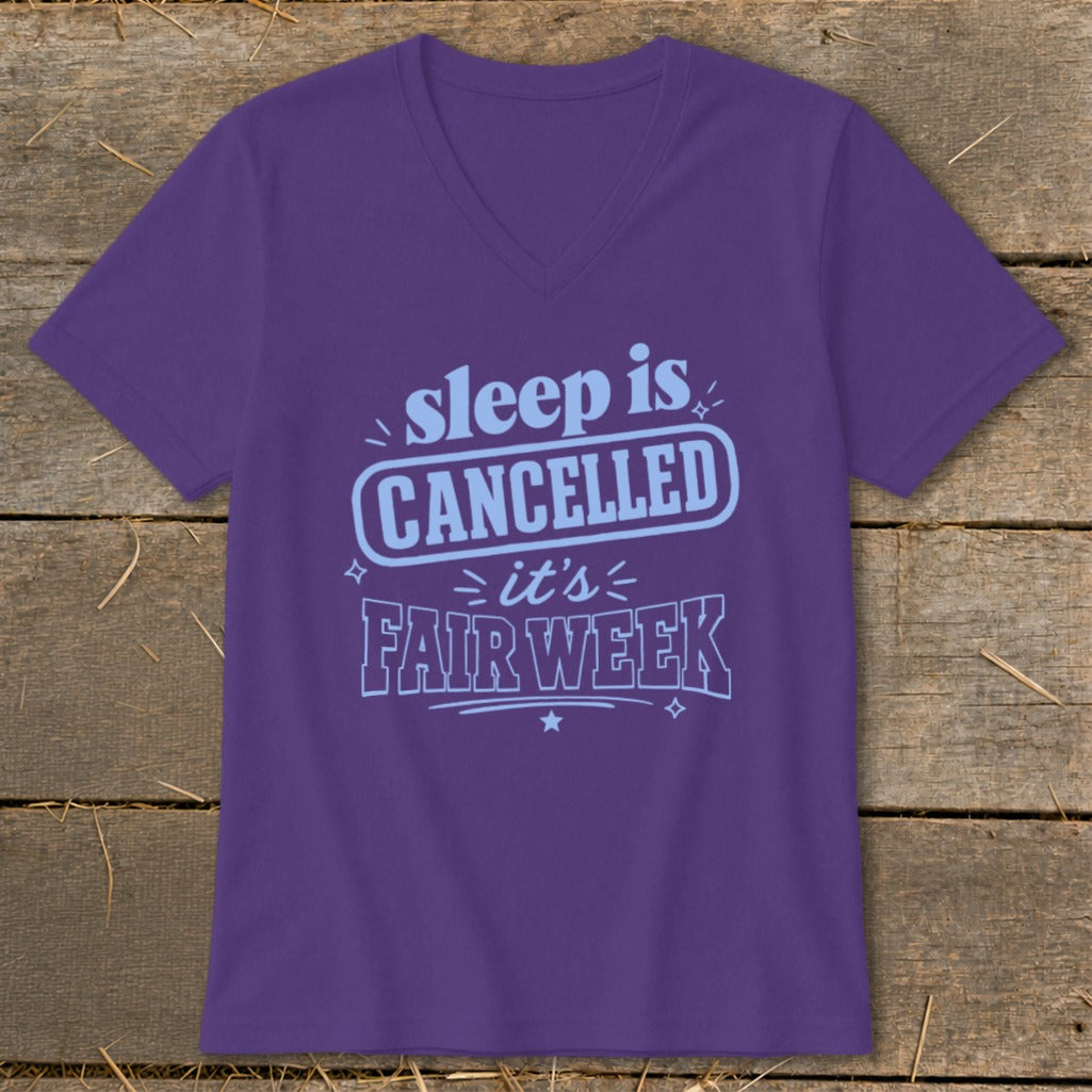 Purple t-shirt with "sleep is CANCELLED it's FAIR WEEK" text in blue.