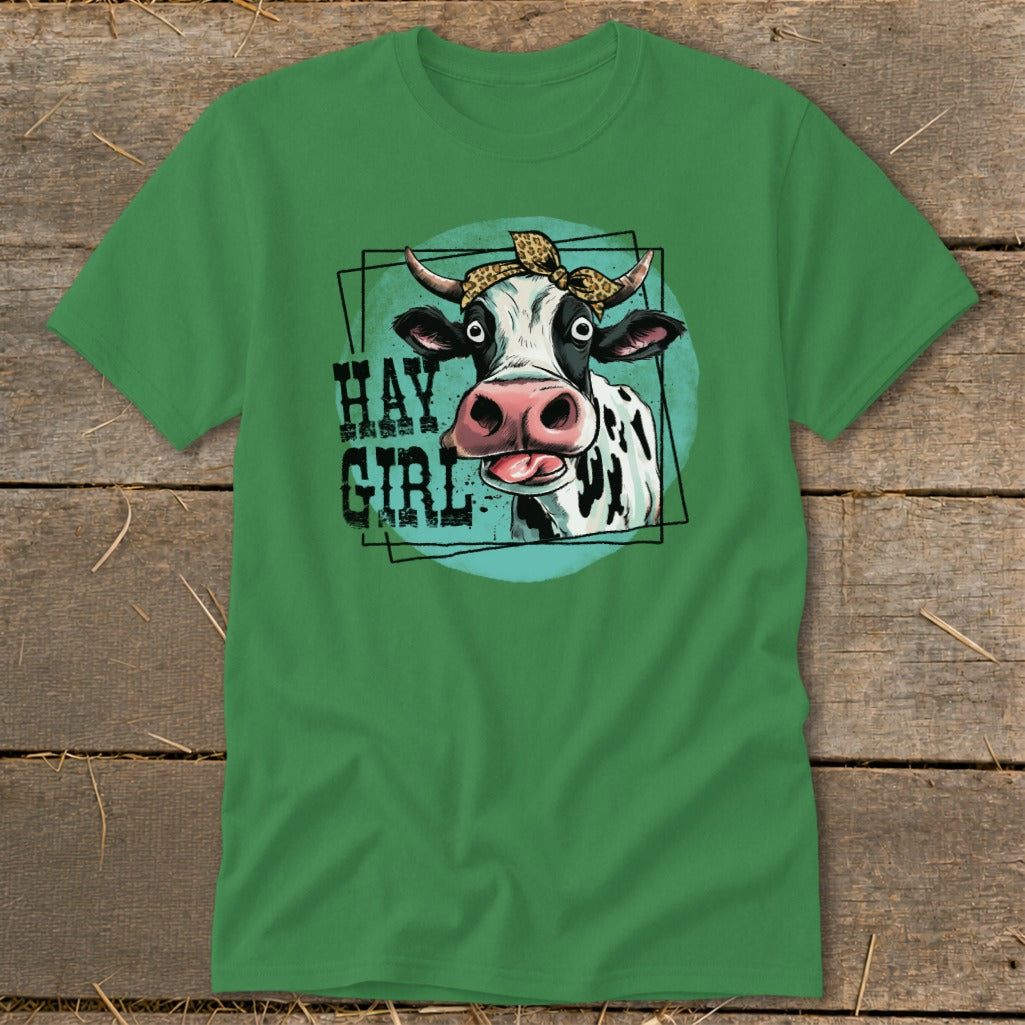 Green t-shirt with a cartoon cow wearing a bandana and text that reads "HAY GIRL".