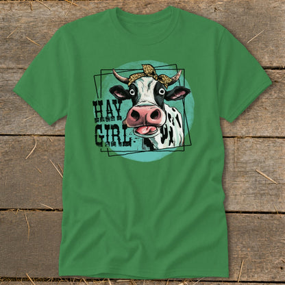 Green t-shirt with a cartoon cow wearing a bandana and text that reads "HAY GIRL".