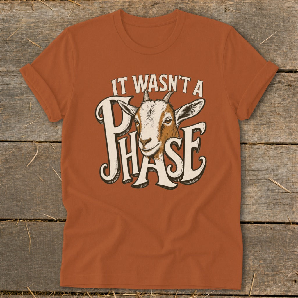 Orange t-shirt with a goat and text "IT WASN'T A PHASE".