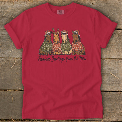 Red t-shirt with four horses in Christmas sweaters and Santa hats, saying "Seasons Greetings from the Herd".