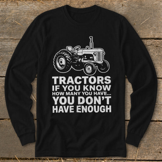Black long sleeve shirt with white tractor graphic and text "Tractors if you know how many you have... you don't have enough."