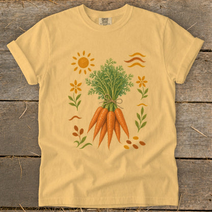 Yellow t-shirt featuring a whimsical carrot harvest illustration with sun, flowers, and leaves.