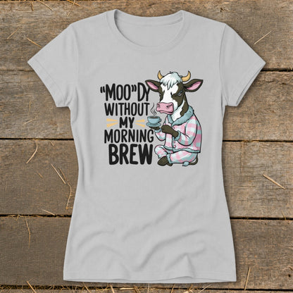 Cow in pajamas holding coffee mug with text "Moo"dy Without My Morning Brew.