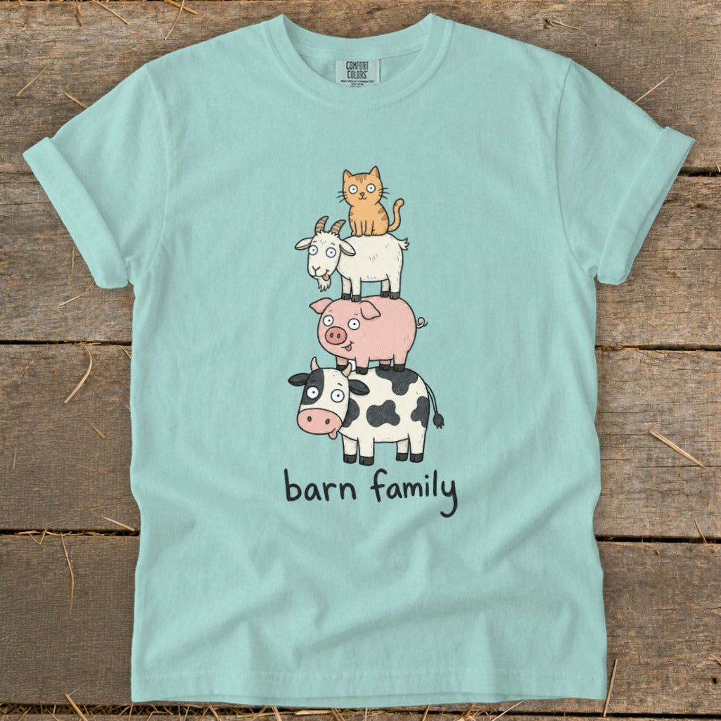 Light blue t-shirt with stacked cartoon cow, pig, goat, and cat graphic saying "barn family."