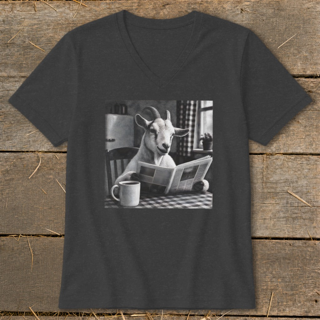 Dark gray V-neck t-shirt featuring a black-and-white graphic of a goat sitting at a table reading a newspaper beside a coffee mug.