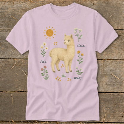 Light pink t-shirt with a fluffy alpaca surrounded by flowers and a sun.
