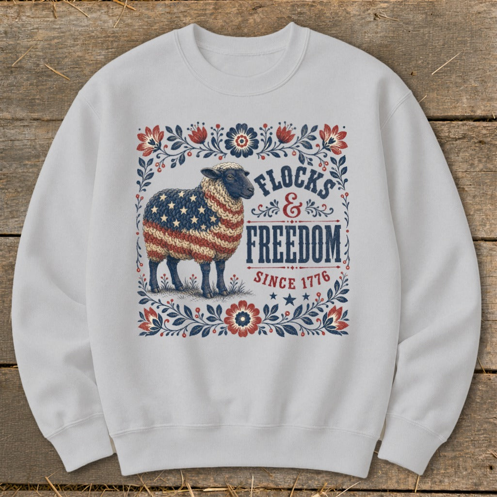 Sheep with American flag fleece, "Flocks & Freedom Since 1776" text.