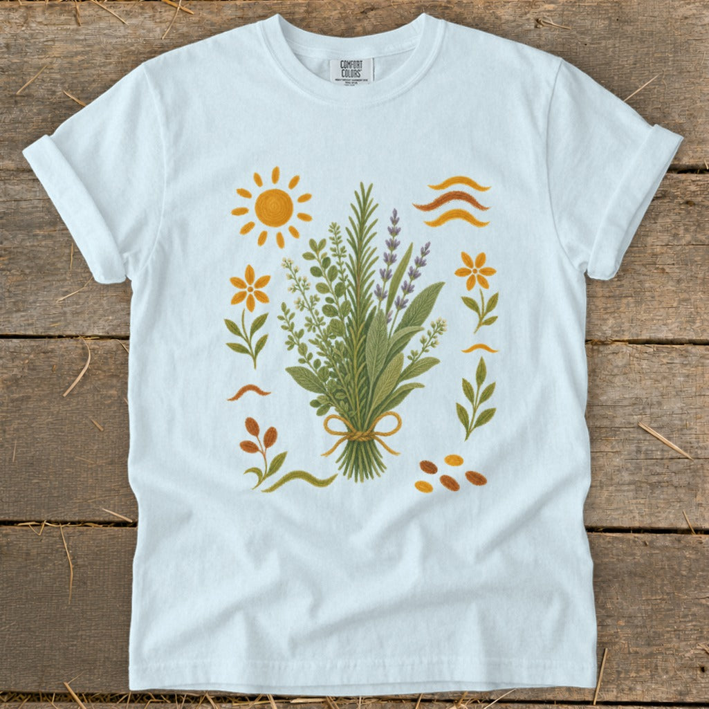 White t-shirt with a botanical illustration of a herb bouquet and floral elements.