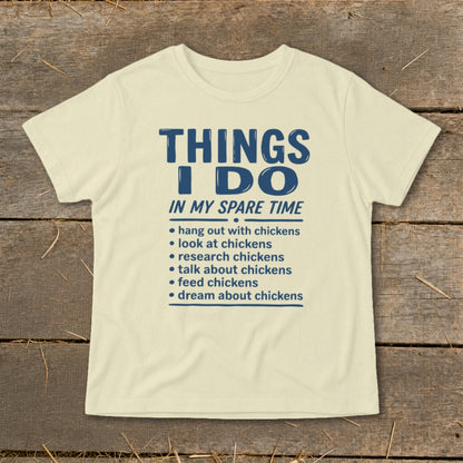 Cream t-shirt with blue text listing chicken-related activities done in spare time.
