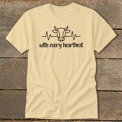 Light yellow t-shirt with cow head and heartbeat graphic and text "with every heartbeat."