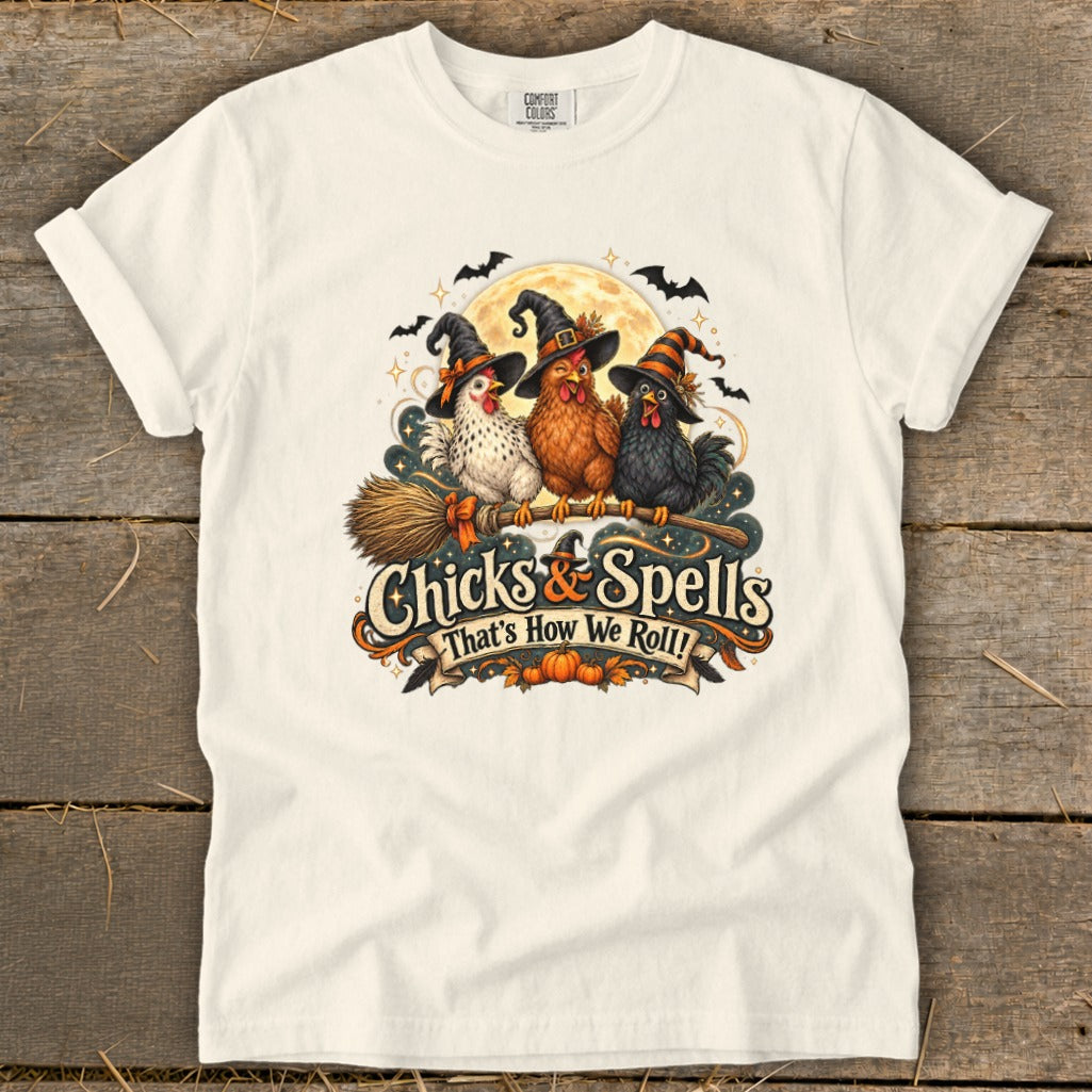Three chickens in witch hats fly on a broomstick with text "Chicks & Spells".