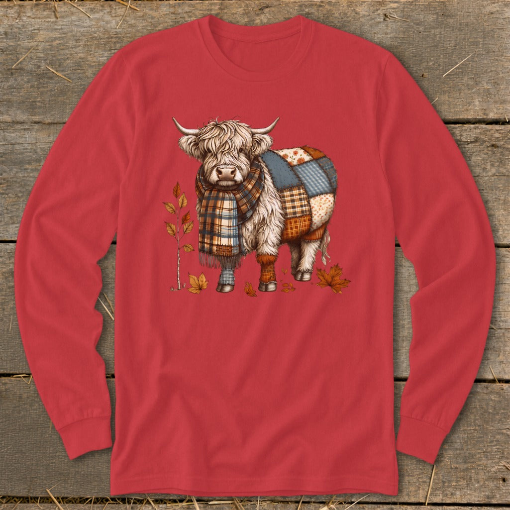 Highland cow with plaid scarf and patchwork body among autumn leaves.