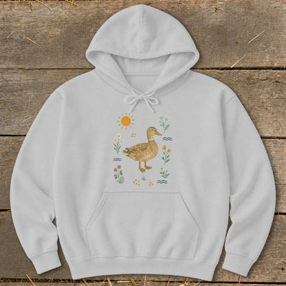 Light grey hoodie with a watercolor illustration of a duck surrounded by flowers and a sun.