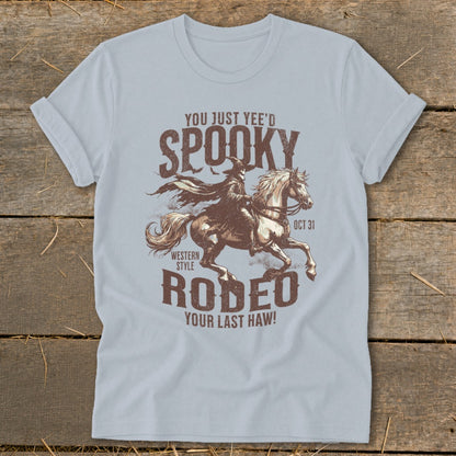 Light blue t-shirt graphic with "Spooky Rodeo" text and a rider on a horse.