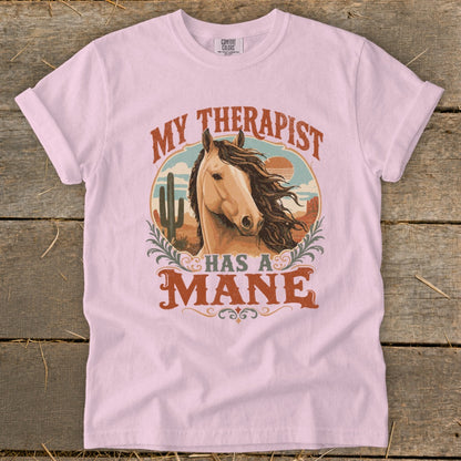 Pink t-shirt with "MY THERAPIST HAS A MANE" text and a horse portrait.