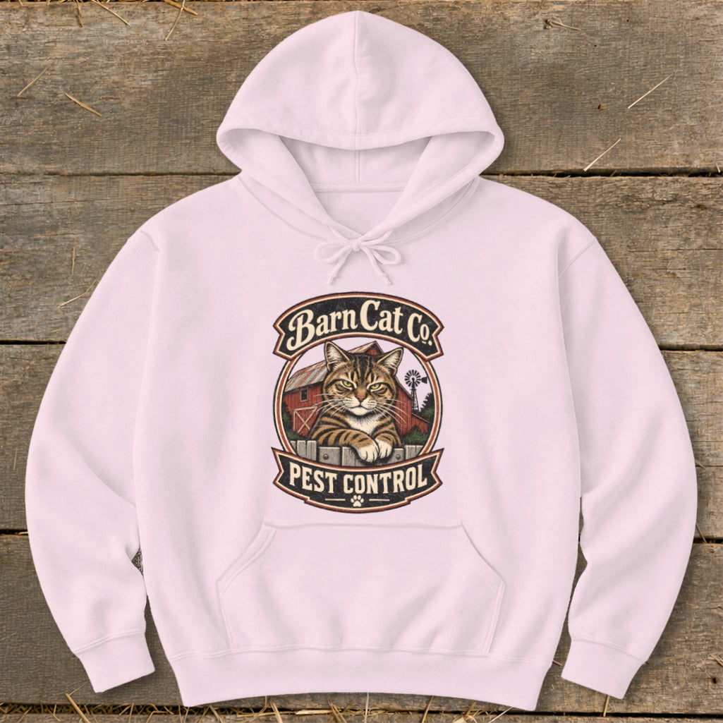 A light pink hooded sweatshirt features a vintage graphic of a tabby cat behind a fence with the text Barn Cat Co. Pest Control.