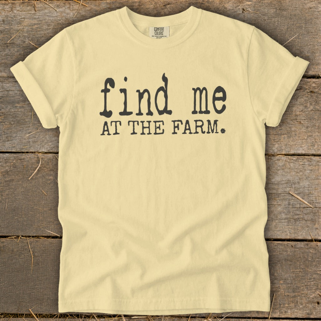 Yellow t-shirt with black text that reads "find me AT THE FARM."