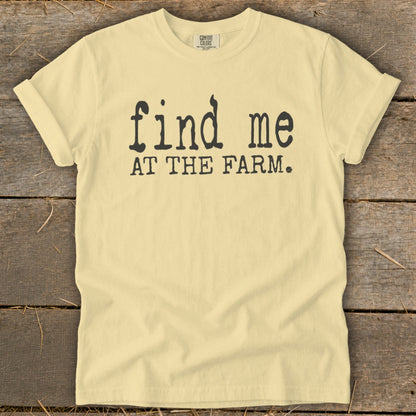 Yellow t-shirt with black text that reads "find me AT THE FARM."