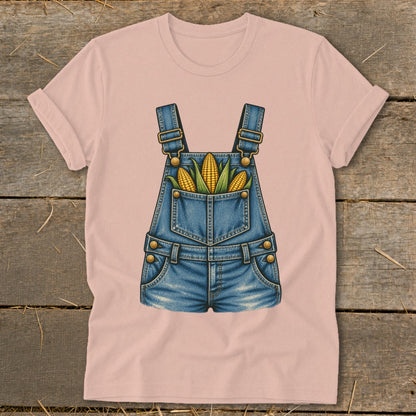 Pink t-shirt with a graphic of denim overalls filled with corn.