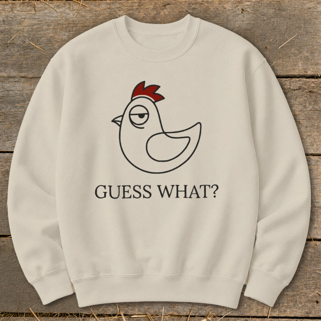 Cream sweatshirt with a cartoon chicken design and "GUESS WHAT?" text.