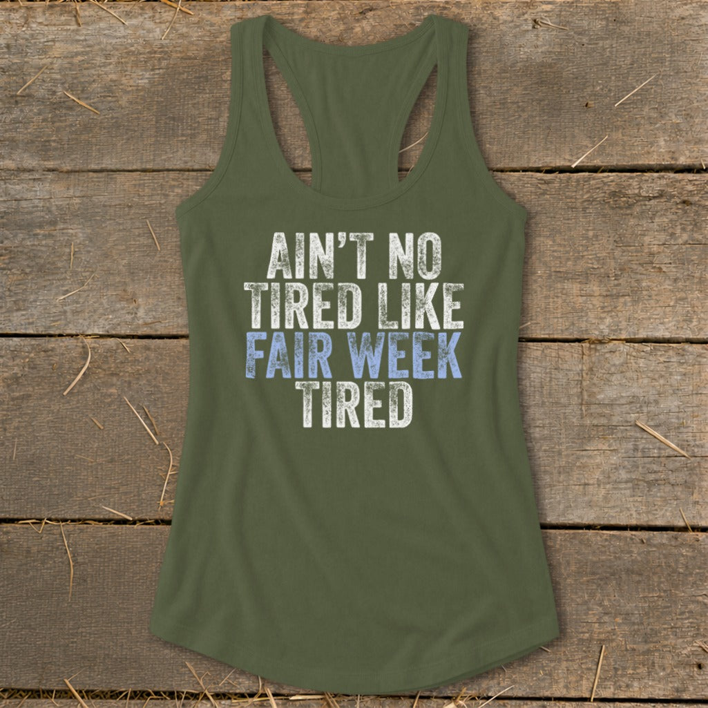 Green tank top with "Ain't No Tired Like Fair Week Tired" text.