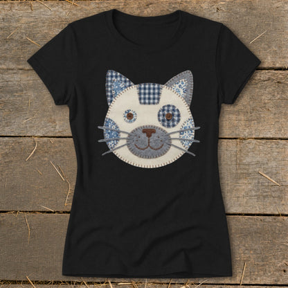 Black t-shirt with a fabric applique cat face featuring blue and white patterns.